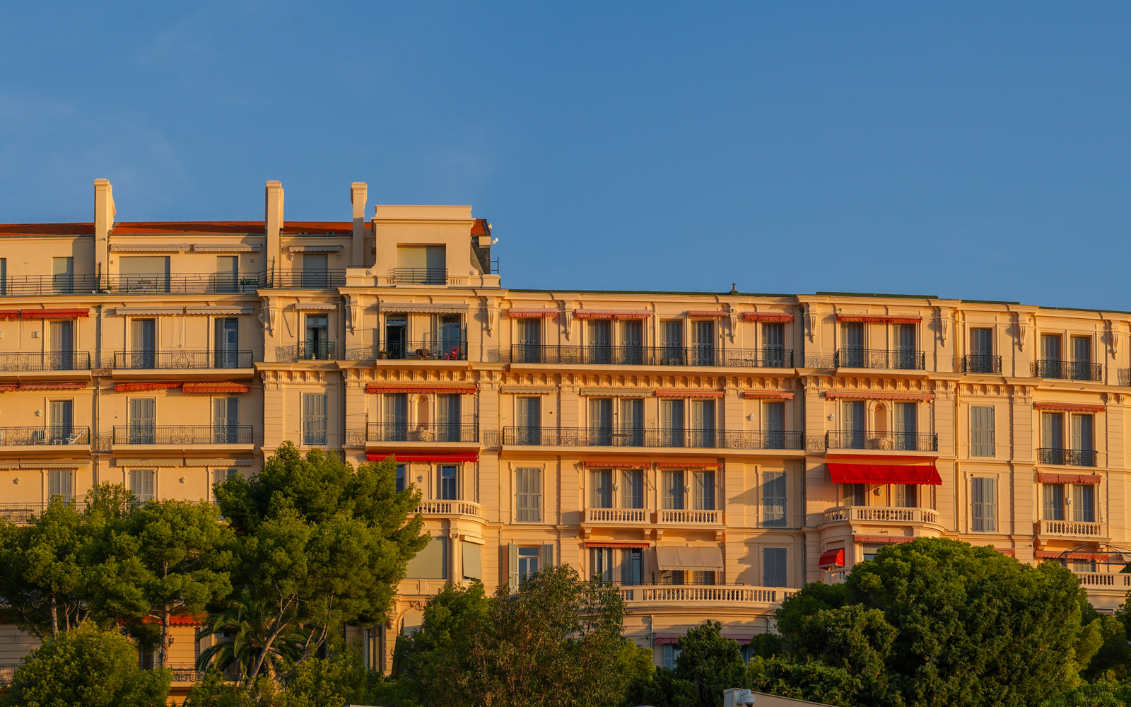 Grand palace hotel facade on the French Riviera at golden hour