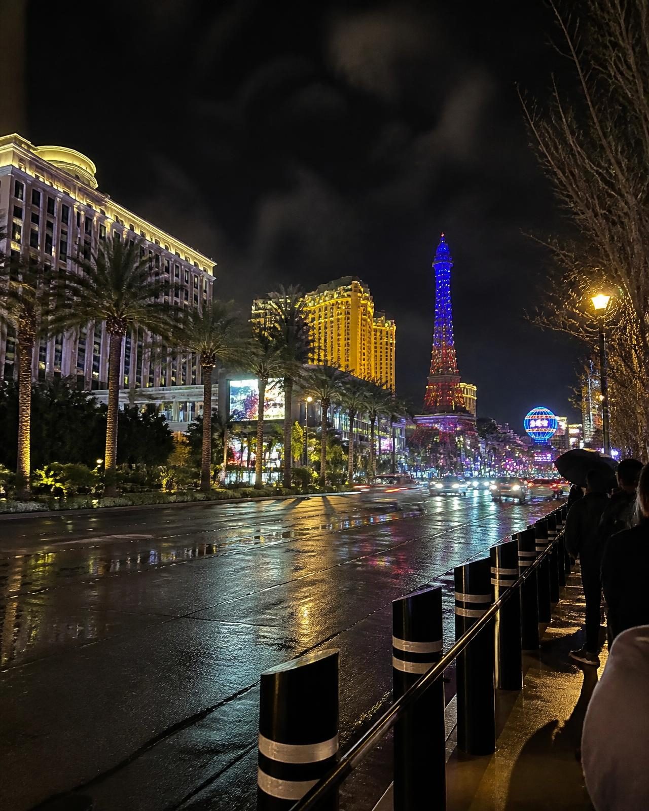 The Las Vegas Strip at night with wet asphalt reflecting neon light