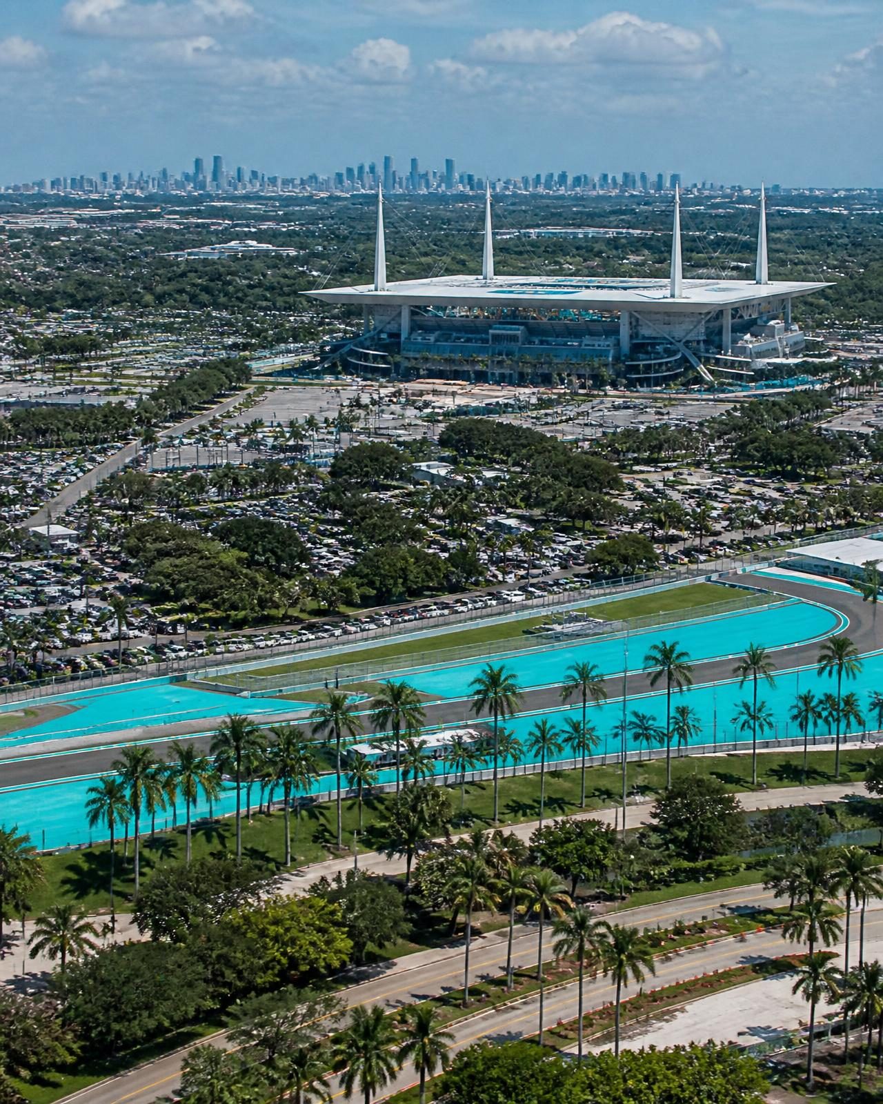 Aerial view of the Miami circuit area with palm trees and the city skyline beyond