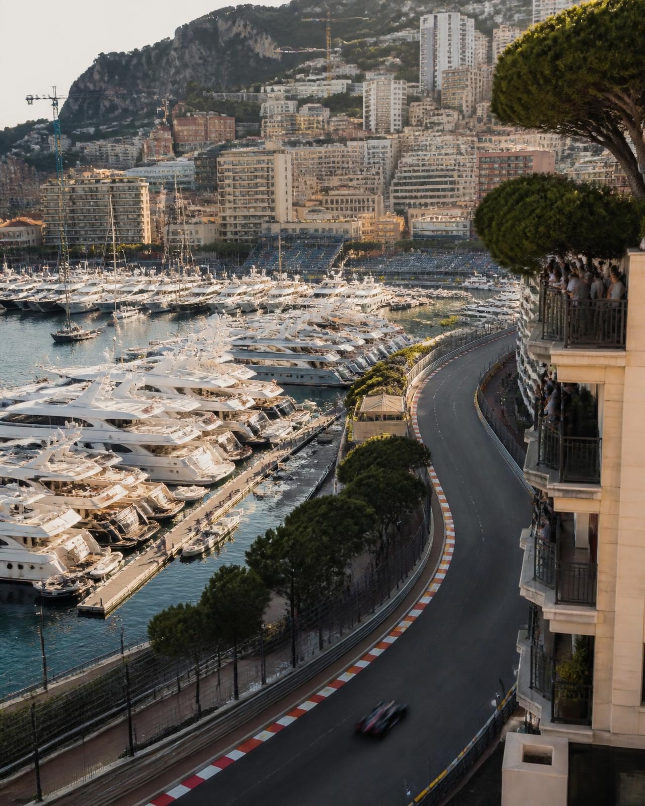 Monaco harbour full of yachts beside the street circuit in late afternoon light