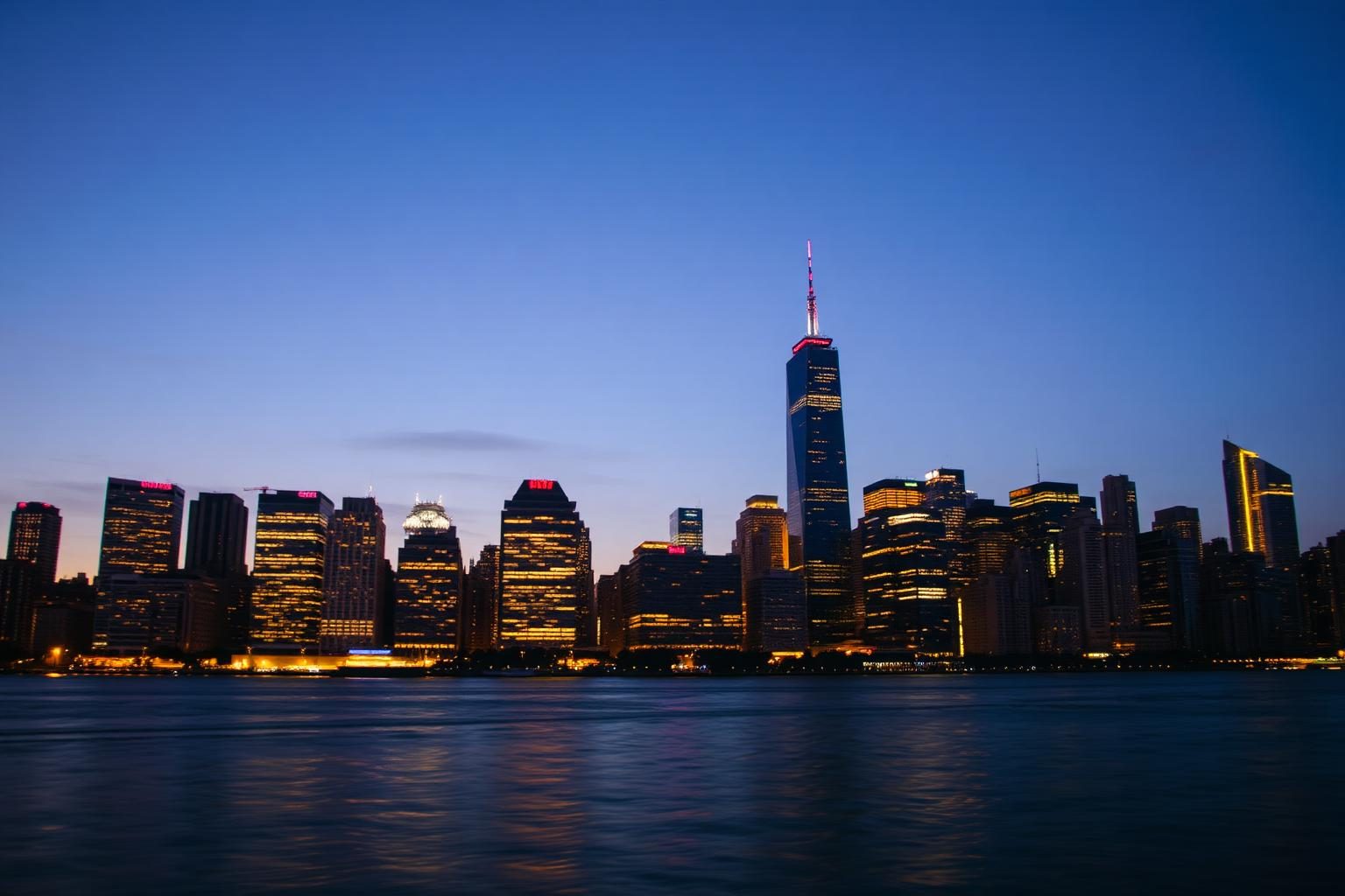 Manhattan skyline at dusk seen across the water