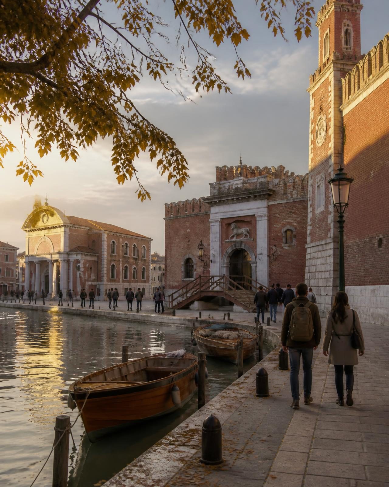 Historic brick pavilions beside a Venetian canal in golden autumn light
